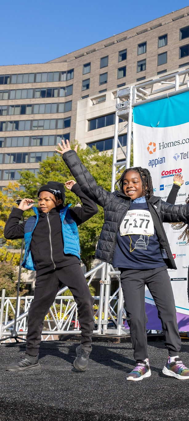 Children dance on stage during the 2026 Race for Every Child.